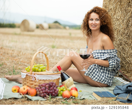 Portrait of topless woman with glass of red wine on picnic Portrait of topless woman with glass of red wine on picnic 129195848
