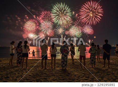 ビーチで花火大会を楽しむ水着の男女カップル ビーチで花火大会を楽しむ水着の男女カップル 129195891
