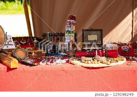 Close up of a table with handcrafted jewelry and accessories. 129196249