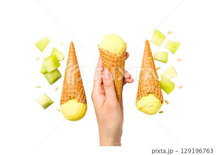 Hand with two cones of melon ice cream, isolated on white, PNG Hand with two cones of melon ice cream, isolated on white, PNG 129196763