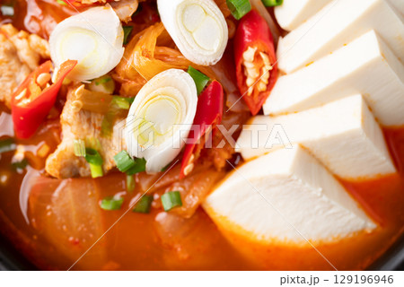 Korean food (Kimchi Jjigae), Kimchi soup with tofu, pork, scallion and chili, Close up, Top view 129196946