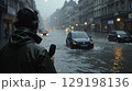 Reporter covering severe urban flooding during heavy rain 129198136