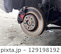 Close-up of Car Brake Disc and Caliper.  Car Tire Repair 129198192