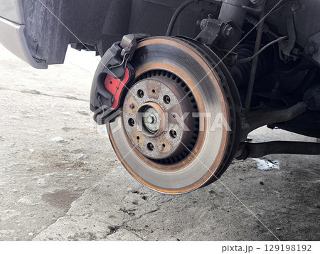 Close-up of Car Brake Disc and Caliper.  Car Tire Repair 129198192