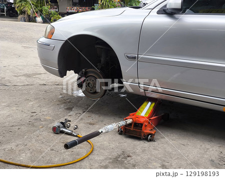 Car Tire Repair and Maintenance with Jack 129198193