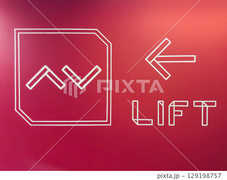Directional signage indicating lift access in a modern facility in Penang, Malaysia 129198757