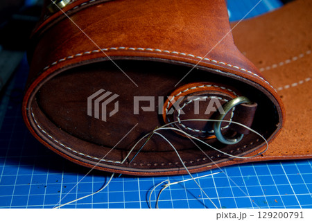 The process of leather processing, making a seam 129200791