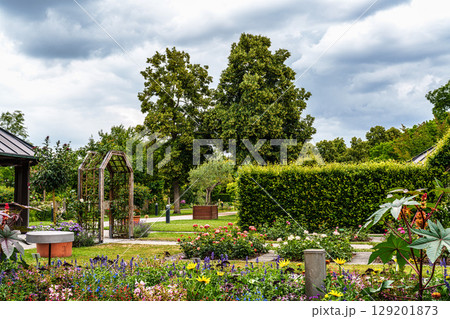 The Botanical Garden of Augsburg in Germany with garden pathes and topiary boxwood bushes on green meadows The Botanical Garden of Augsburg in Germany with garden pathes and topiary boxwood bushes on green meadows 129201873