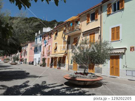 Old street in Italian countryside near sea. Traditional building. Sun day. Entrance, window to house. Nature and sky. Old street in Italian countryside near sea. Traditional building. Sun day. Entrance, window to house. Nature and sky. 129202205