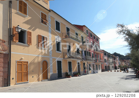 Old street in Italian countryside near sea. Traditional building. Sun day. Entrance, window to house. Nature and sky. 129202208