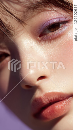 Close-up of a young Korean woman showcasing natural makeup in soft light, emphasizing skin texture and elegance 129202637