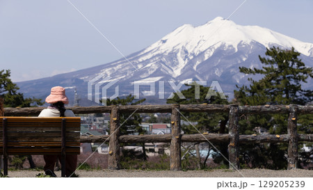 woman have a look to Mount Iwaki, it is the highest mountain in Aomori Prefecture, Japan woman have a look to Mount Iwaki, it is the highest mountain in Aomori Prefecture, Japan 129205239