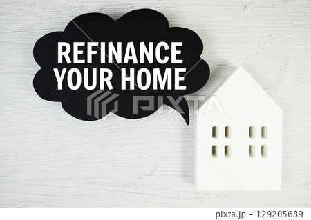 Refinance Your Home text message on speech bubble with house model on concrete background Refinance Your Home text message on speech bubble with house model on concrete background 129205689