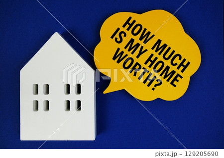 How Much Is My House Worth text on speech bubble and house model on blue background 129205690