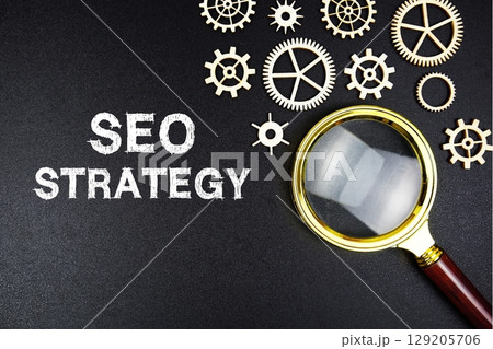 SEO Strategy text message with magnifying glass on black background 129205706