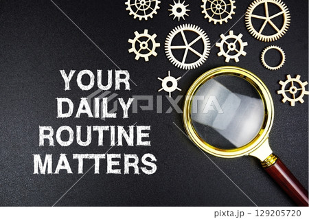 Your Daily Routine Matters text message with magnifying glass on black background 129205720