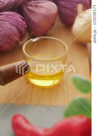 Cooking ingredients on a wooden board with oil and garlic 129206173