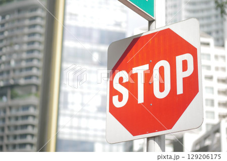 Bright stop sign in an urban setting during daytime 129206175