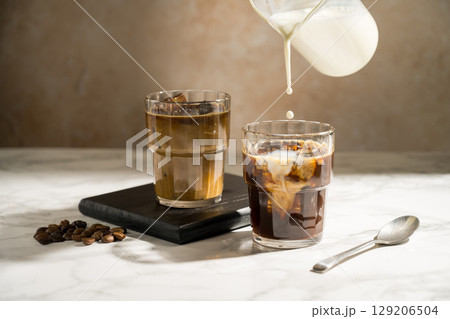 Glass with iced latte, refreshing energy coffee drinks Glass with iced latte, refreshing energy coffee drinks 129206504