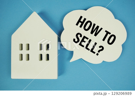 How to Sell? text with house model and magnifying glass on blue background How to Sell? text with house model and magnifying glass on blue background 129206989