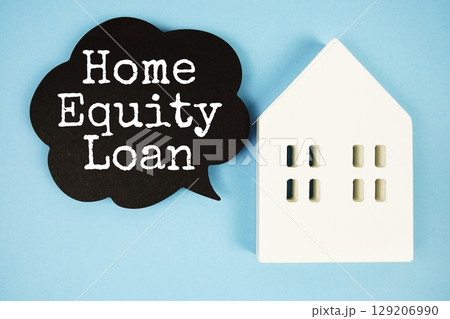 Home Equity Loan text with house model on blue background Home Equity Loan text with house model on blue background 129206990