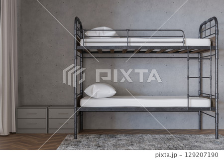 Bunk beds arranged in a stylish hostel interior, complemented by neutral walls and wooden flooring. A tidy and inviting atmosphere perfect for travelers seeking comfort and convenience 129207190