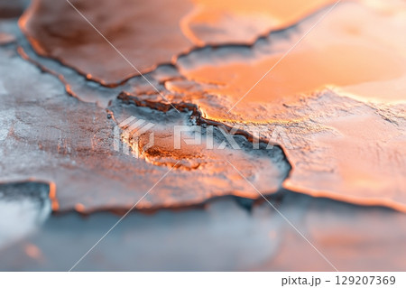 Detailed close-up captures the beauty of frozen water, showcasing soft cracks and unique reflections. The clean aesthetic offers an ideal backdrop for branding opportunities and creative projects 129207369