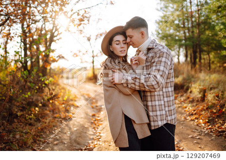 Stylish couple walking and enjoying autumn weather. People, lifestyle, vacations concept. Autumn. Stylish couple walking and enjoying autumn weather. People, lifestyle, vacations concept. Autumn. 129207469