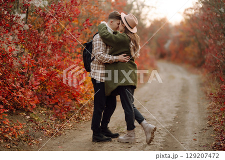 Stylish couple walking and enjoying autumn weather. People, lifestyle, vacations concept. Autumn. Stylish couple walking and enjoying autumn weather. People, lifestyle, vacations concept. Autumn. 129207472