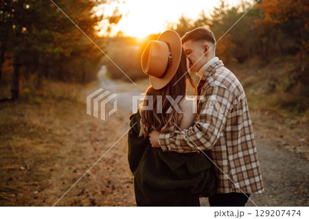 Happy couple in love newlyweds travel together, hike and walk in the autumn forest in nature. Happy couple in love newlyweds travel together, hike and walk in the autumn forest in nature. 129207474