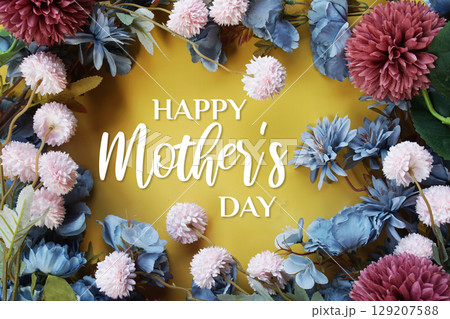 Happy Mother's Day text with flowers decoration on yellow background Happy Mother's Day text with flowers decoration on yellow background 129207588