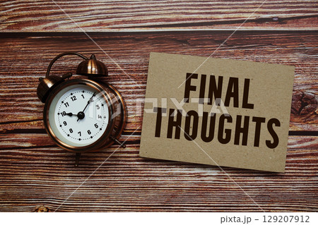 Final Thoughts text with alarm clock on wooden background 129207912