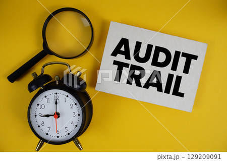 Audit Trail text written on paper with magnifying glass and alarm clock on yellow background Audit Trail text written on paper with magnifying glass and alarm clock on yellow background 129209091
