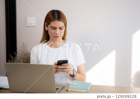Young caucasian businesswoman texting with serious and concentration with laptop. Young caucasian businesswoman texting with serious and concentration with laptop. 129209228