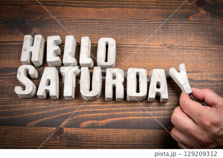 Hello Saturday Concept with Concrete Letters on Wooden Background Hello Saturday Concept with Concrete Letters on Wooden Background 129209312