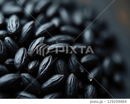 Macro of Raw Black Rice Grains with Intricate Matte Texture and Soft Top Lighting 129209864