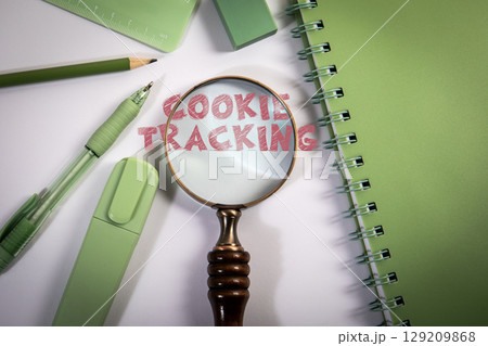 Cookie Tracking Concept with Magnifying Glass and Office Supplies Cookie Tracking Concept with Magnifying Glass and Office Supplies 129209868