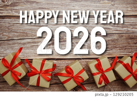 Happy New Year 2026 typography text with gift box on wooden background 129210205