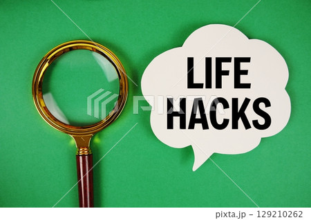 Life Hacks text with speech bubble and magnifying glass on green background 129210262