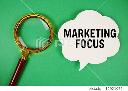 Marketing Focus text with speech bubble and magnifying glass on green background Marketing Focus text with speech bubble and magnifying glass on green background 129210264