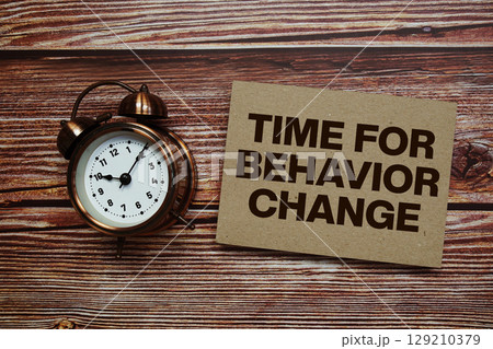 Time For Behavior Change text with alarm clock on wooden background Time For Behavior Change text with alarm clock on wooden background 129210379