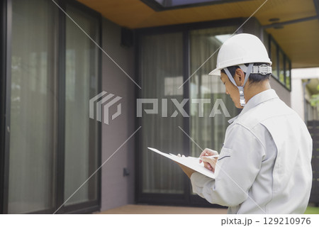住まいのチェックをする建築士男性 129210976