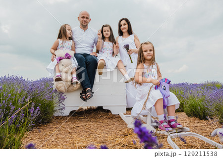 The family relaxes in the picturesque lavender field 129211538