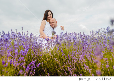 A boy and a girl in love embracing in a lavender field A boy and a girl in love embracing in a lavender field 129211592