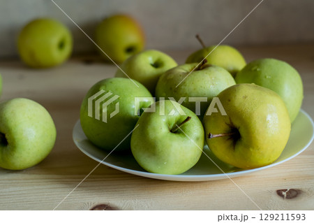 An apple that accidentally rolled off the table makes the scene lively An apple that accidentally rolled off the table makes the scene lively 129211593