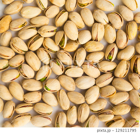 roasted pistachios on white background 129211795