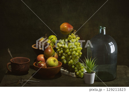Still life with fruits and dishes on the table Still life with fruits and dishes on the table 129211823