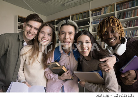 Joyful multiracial diverse teenage students hug for funny group portrait 129212133