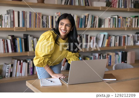 Woman using laptop, enjoy work results, achievements and productive workday Woman using laptop, enjoy work results, achievements and productive workday 129212209
