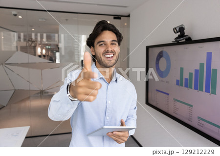 Charismatic smiling young businessman team leader pointing finger at camera 129212229